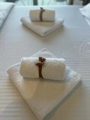 a couple of towels sitting on top of a bed at Solis BW Apartments in Belgrade