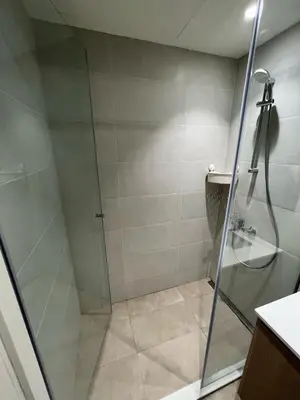 a shower with a glass door in a bathroom at Solis BW Apartments in Belgrade