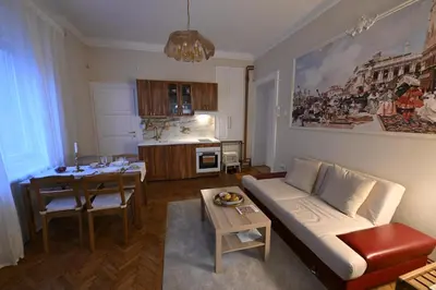 a living room with a couch and a table at La Mascarade in Belgrade