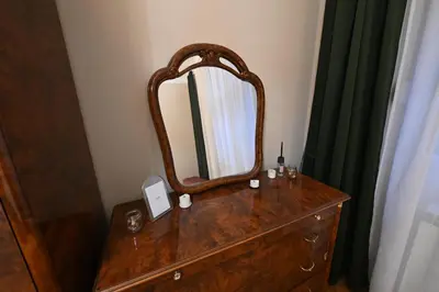 a bathroom with a wooden dresser with a mirror on it at La Mascarade in Belgrade
