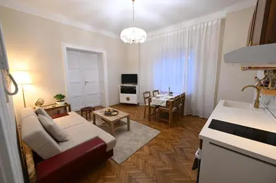 a living room with a couch and a table at La Mascarade in Belgrade