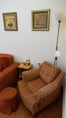a living room with a couch and a ottoman at Apartment Akacija Gardens in Belgrade