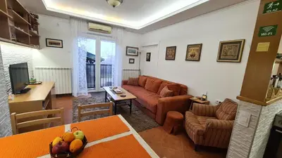 a living room with a couch and a table at Apartment Akacija Gardens in Belgrade