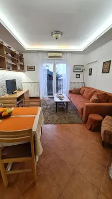 a living room with a couch and a table at Apartment Akacija Gardens in Belgrade