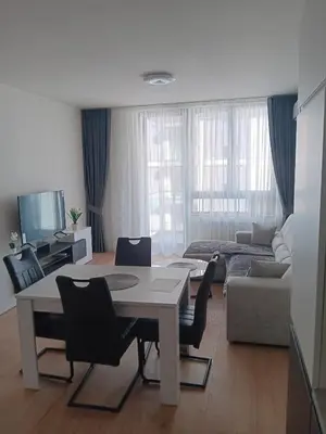 a living room with a table and chairs and a couch at BW Echo Lux Apartment - Belegrade Waterfront in Belgrade