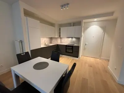 a kitchen and dining room with a white table and chairs at BW Echo Lux Apartment - Belegrade Waterfront in Belgrade