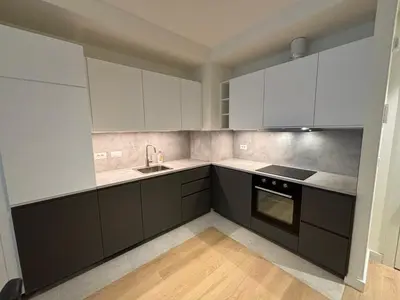 a kitchen with black and white cabinets and a sink at BW Echo Lux Apartment - Belegrade Waterfront in Belgrade
