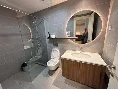a bathroom with a toilet and a sink and a mirror at BW Echo Lux Apartment - Belegrade Waterfront in Belgrade