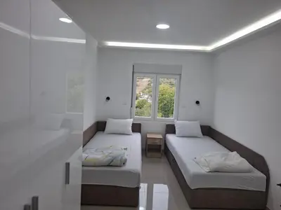 a room with two beds and a window at Apartman SARA in Smederevo