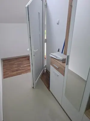 a glass door leading into a bathroom with a sink at Apartman SARA in Smederevo