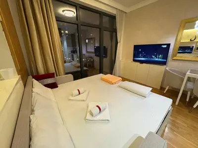 a living room with a white table with two napkins at Lunalux BW Apartments in Belgrade