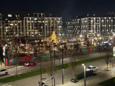 a city at night with a christmas tree and buildings at Lunalux BW Apartments in Belgrade
