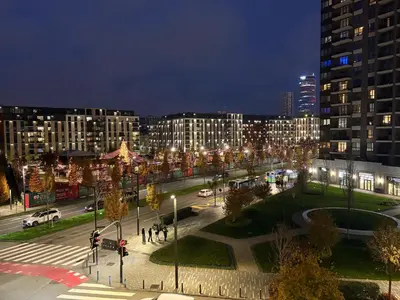 a city street at night with buildings and lights at Lunalux BW Apartments in Belgrade