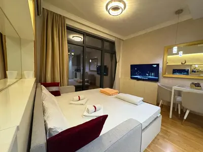 a room with a white table and red chairs at Lunalux BW Apartments in Belgrade