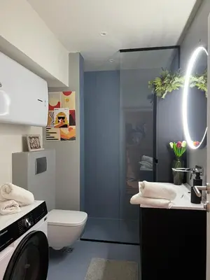 a bathroom with a toilet and a sink and a washing machine at Sovica- Taš in Belgrade