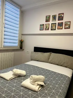 a bedroom with a bed with two towels on it at Sovica- Taš in Belgrade