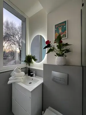 a bathroom with a sink and a window at Sovica- Taš in Belgrade
