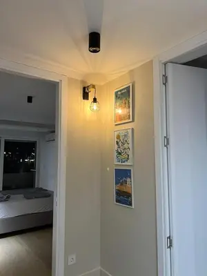 a hallway with a room with a bed and some pictures at Sovica- Taš in Belgrade
