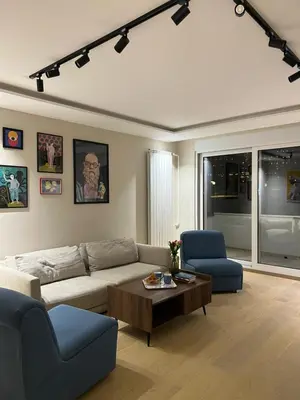 a living room with a couch and two chairs and a table at Sovica- Taš in Belgrade