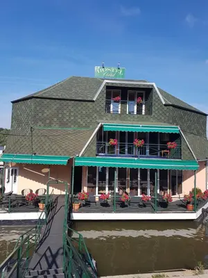 a house on a boat in the water at Hostel Otard in Belgrade