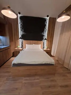 a bedroom with a large bed and two tables at Premium City Center TOP LOCATION apartments in Belgrade