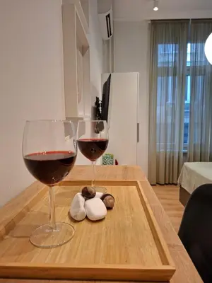two glasses of wine sitting on a wooden tray at Premium City Center TOP LOCATION apartments in Belgrade