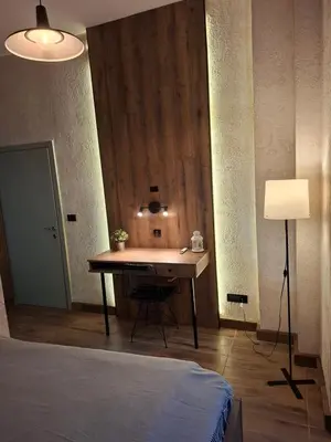 a bedroom with a desk with a lamp and a bed at Premium City Center TOP LOCATION apartments in Belgrade