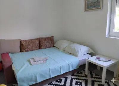 a small room with a bed and a table at Spring Hill in Belgrade
