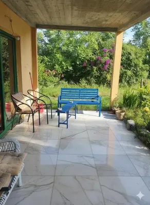 a blue bench and chairs on a patio at Spring Hill in Belgrade