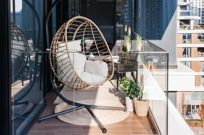 a hanging chair on the balcony of a building at WF 104m2 Prestige with Terrace, Gym and Pool in Belgrade