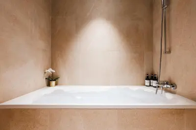 a bath tub in a bathroom with a sink at WF 104m2 Prestige with Terrace, Gym and Pool in Belgrade