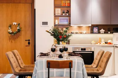 a kitchen with a table with wine glasses on it at WF 104m2 Prestige with Terrace, Gym and Pool in Belgrade