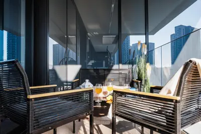 a balcony with two chairs and a table with drinks at WF 104m2 Prestige with Terrace, Gym and Pool in Belgrade