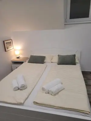 a bedroom with two beds with towels on them at Beosan in Železnička Stanica Zemunsko Polje