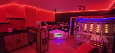 a red room with a tub and a mirror at Apartman Fantazy spa BDSM in Zemun