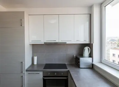 a kitchen with white cabinets and a microwave at Apartment Admiral in Belgrade