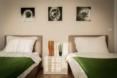 two beds sitting next to each other in a bedroom at Apartment Admiral in Belgrade