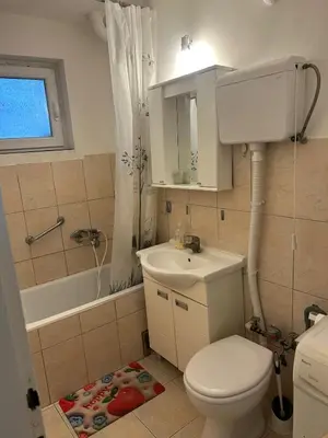 a bathroom with a toilet and a sink and a tub at Apartman Borkica in Mladenovac