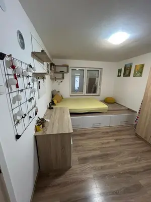 a bedroom with a bed in the corner of a room at Apartman Borkica in Mladenovac
