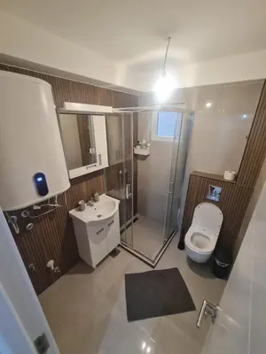 a bathroom with a shower and a toilet and a sink at Marash 3 in Belgrade