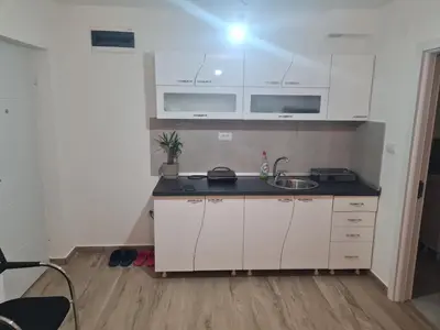 a kitchen with white cabinets and a sink at Marash 3 in Belgrade