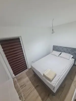 a small bedroom with a bed and a window at Marash 3 in Belgrade