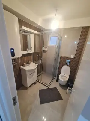 a bathroom with a toilet and a shower and a sink at Marash 3 in Belgrade