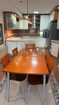 a wooden table and chairs in a kitchen at vila filip in Belgrade