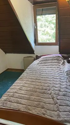 a large bed in a room with a window at vila filip in Belgrade