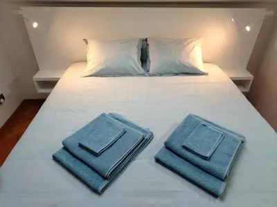 a bed with two blue towels on top of it at LoLo apartment Belgrade in Beograd