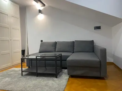 a living room with a couch and a table at LoLo apartment Belgrade in Beograd