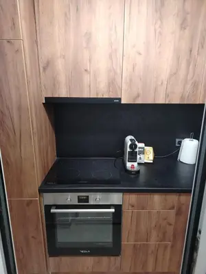 a kitchen with a stove and a phone on a counter at LoLo apartment Belgrade in Beograd