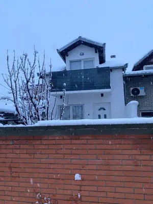 a building with snow on top of a brick wall at LoLo apartment Belgrade in Beograd