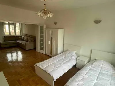 a bedroom with a bed and a living room at New Luxury Strict Center Apartment in Belgrade